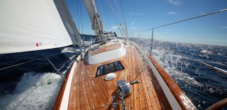 Front view of Hallberg Rassy 55 sailing in the sun 