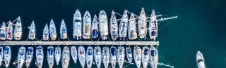 Aerial view on marina bay with sailboats and yachts.